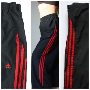 black adidas joggers with red stripes